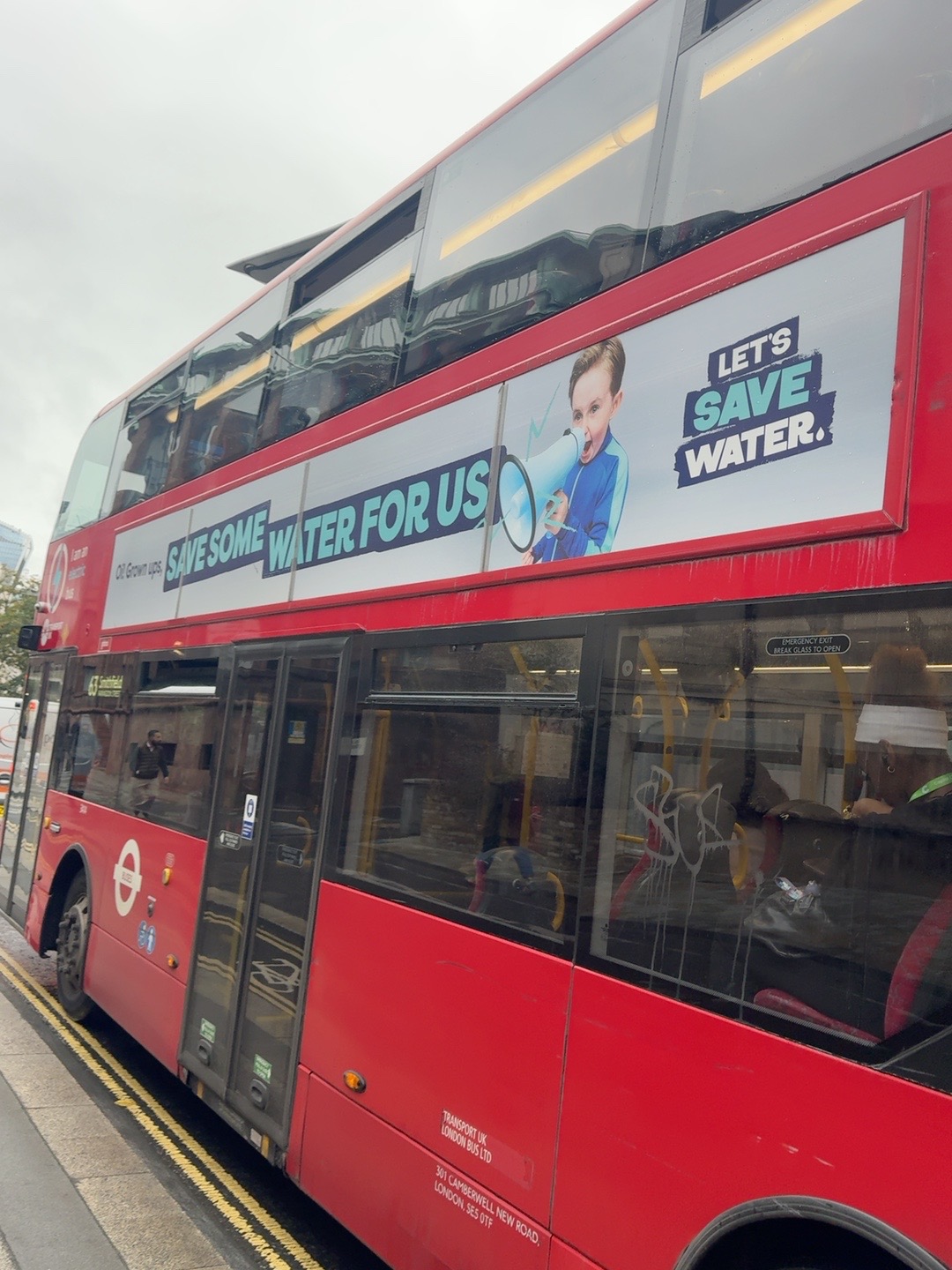 Let’s Save Water campaign advert on the side of a London bus, featuring a child and the words Save Some Water For Us